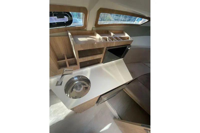 Slide: The Image of Interior of 2023 NX Boats 340 Sport Coupe featuring modern kitchenette design. - 8