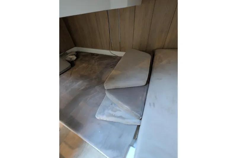 Slide: The Image of Interior cabin of 2023 NX Boats 340 Sport Coupe with cushions and wood paneling. - 93