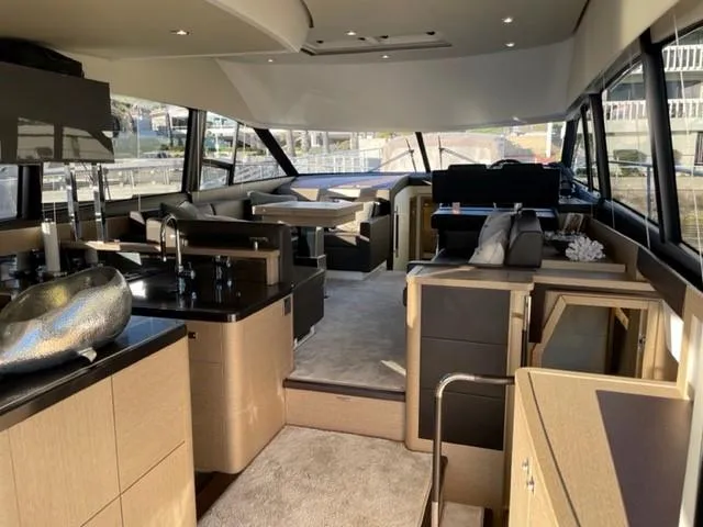 Slide: The Image of Luxurious interior of a 2017 Prestige 500 yacht with modern furnishings and ample natural light. - 14