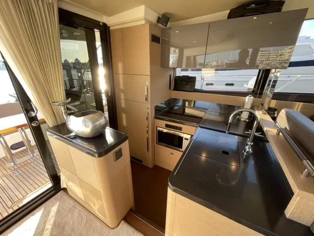 Slide: The Image of Luxurious kitchen interior of 2017 Prestige 500 yacht, featuring modern appliances and sleek design. - 15