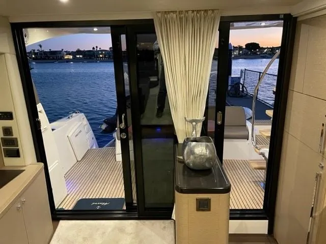 Slide: The Image of Interior view of a 2017 Prestige 500 yacht, showcasing elegant design and waterfront scenery. - 17