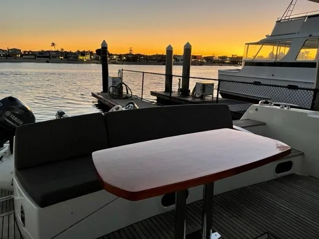 Slide: The Image of Prestige 500 yacht deck at sunset, 2017 model, with waterfront view. - 2