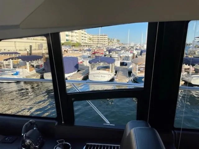 Slide: The Image of View from a 2017 Prestige 500 yacht overlooking a busy marina with docked boats. - 21