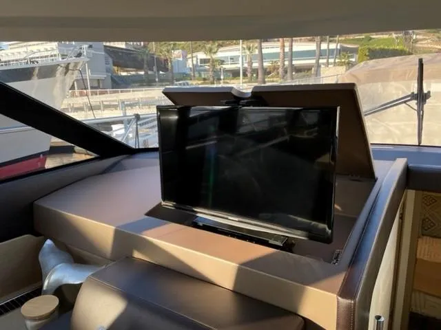 Slide: The Image of Luxurious 2017 Prestige 500 yacht interior with retractable TV in the cabin. - 22