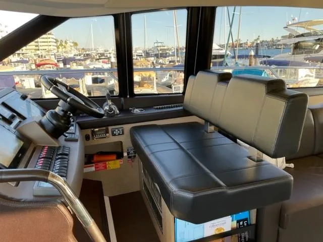 Slide: The Image of Interior of a 2017 Prestige 500 yacht cockpit with leather seating and control panel. - 23