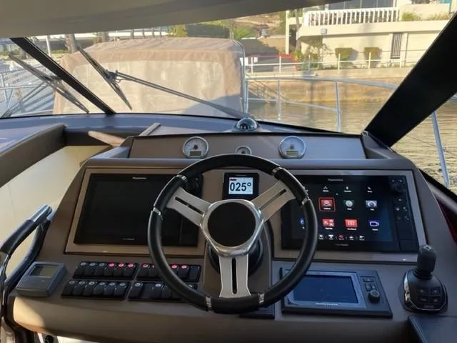 Slide: The Image of Cockpit of 2017 Prestige 500 yacht with modern navigation controls and steering wheel. - 24