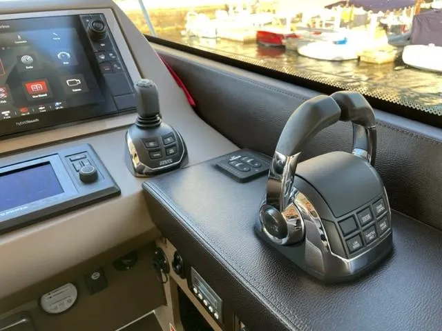 Slide: The Image of Control panel of a 2017 Prestige 500 yacht with joystick and throttle levers. - 25