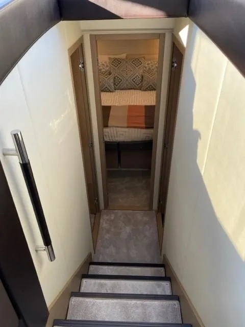 Slide: The Image of Staircase leading to a cozy bedroom in a 2017 Prestige 500 yacht. - 26