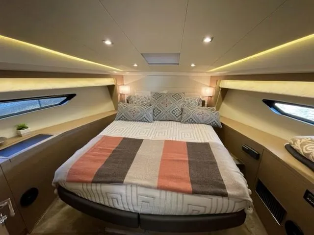 Slide: The Image of Luxurious bedroom interior of 2017 Prestige 500 yacht with modern lighting and cozy bedding. - 27
