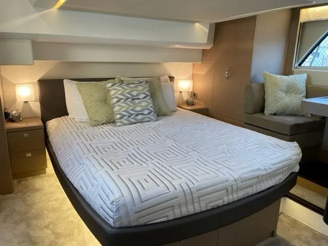 Slide: The Image of Luxurious bedroom interior of a 2017 Prestige 500 yacht with modern decor and cozy lighting. - 3