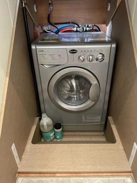 Slide: The Image of Compact washing machine in a wooden cabinet, Prestige 500 model, 2017, with cleaning supplies. - 34