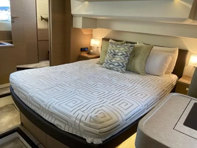 Slide: The Image of Luxurious bedroom interior of a 2017 Prestige 500 yacht with elegant bedding and ambient lighting. - 39