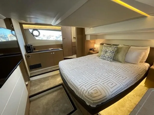 Slide: The Image of Luxurious 2017 Prestige 500 yacht bedroom with modern decor and elegant bedding. - 40