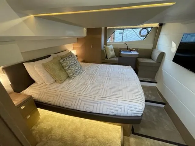 Slide: The Image of Luxurious cabin interior of a 2017 Prestige 500 yacht with elegant bedding and seating area. - 41