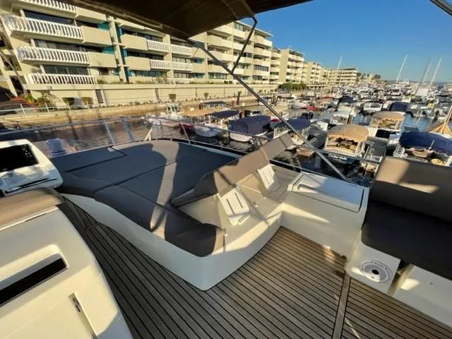 Slide: The Image of Luxurious 2017 Prestige 500 yacht deck with sun loungers, docked in a marina. - 49
