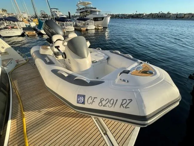 Slide: The Image of 2017 Prestige 500 boat docked at marina, surrounded by other vessels. - 6