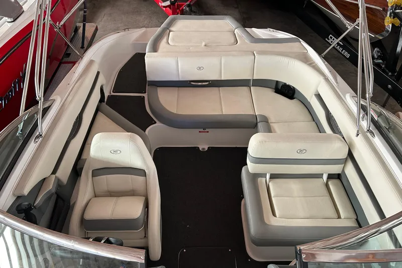 Slide: The Image of 2021 Cobalt CS22 boat interior with white and gray seating, spacious layout. - 13