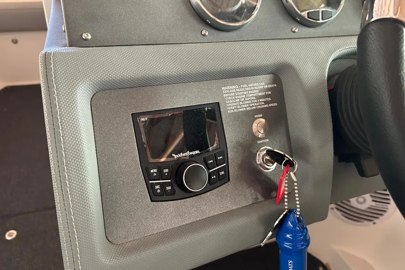 Slide: The Image of Dashboard of a 2021 Cobalt CS22 boat with ignition and audio controls. - 16