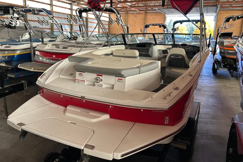 Slide: The Image of 2021 Cobalt CS22 boat in storage, featuring red and white design. - 4