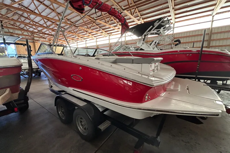 Slide: The Image of 2021 Cobalt CS22 boat in a storage facility, featuring a sleek red and white design. - 6