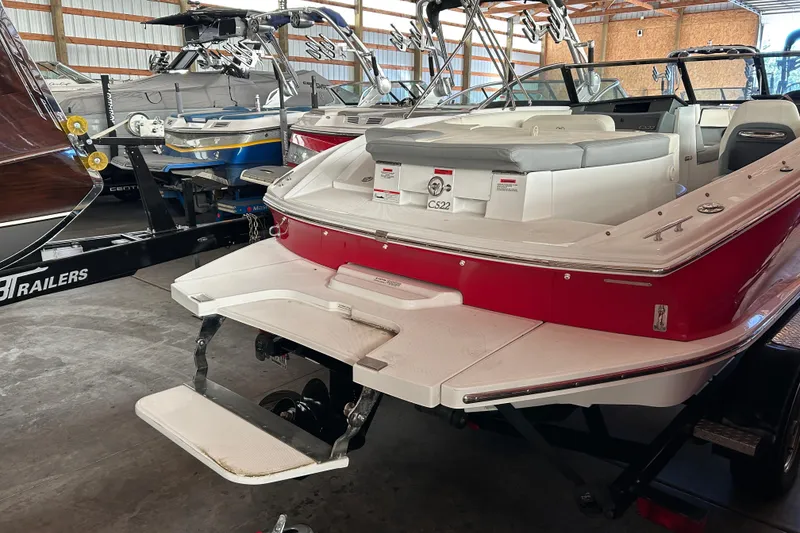 Slide: The Image of 2021 Cobalt CS22 boat in storage, featuring a red and white exterior. - 7