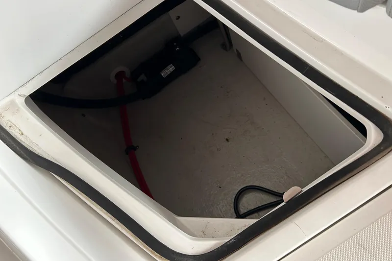 Slide: The Image of Open storage compartment in 2021 Cobalt CS22 boat, showing interior wiring. - 8
