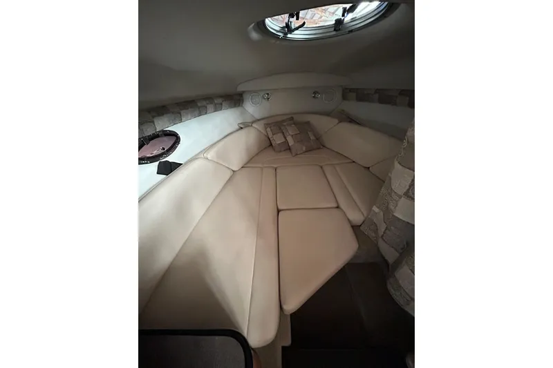 Slide: The Image of 2008 Crownline 230 CCR cabin interior with beige seating and decorative pillows. - 18