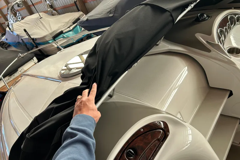 Slide: The Image of 2008 Crownline 230 CCR boat with cover being removed in storage. - 4