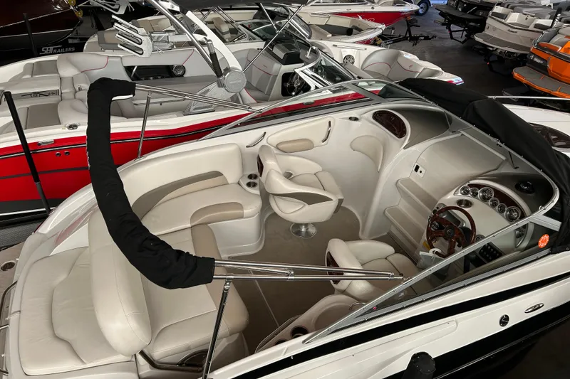 Slide: The Image of 2008 Crownline 230 CCR boat interior with white seating and sleek dashboard. - 5