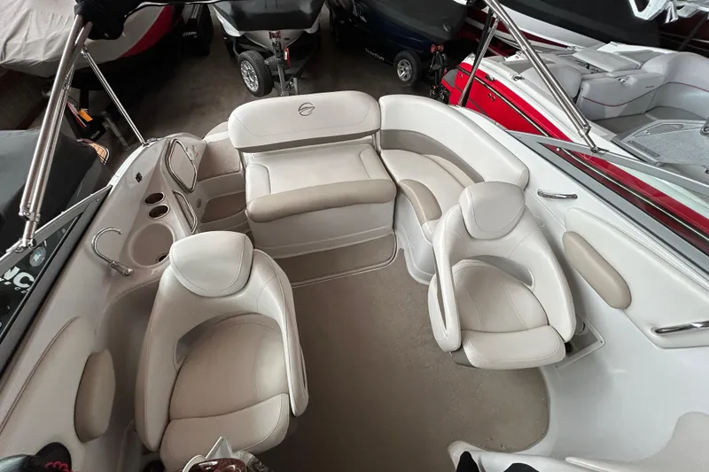 Slide: The Image of 2008 Crownline 230 CCR boat interior with white leather seating and cup holders. - 8
