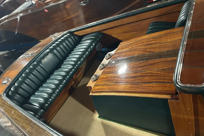 Slide: The Image of 2010 StanCraft 27 Lowboy boat interior with polished wood and leather seating. - 13
