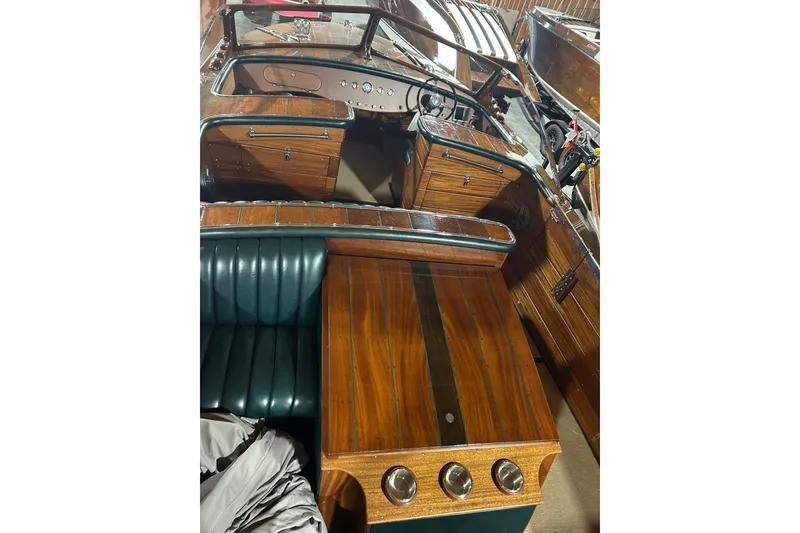 Slide: The Image of 2010 StanCraft 27 Lowboy boat interior with polished wood and leather seating. - 14