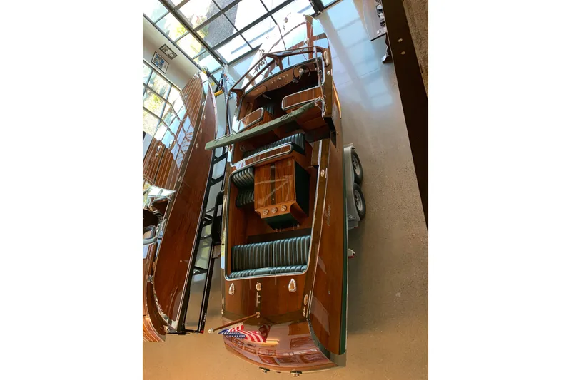 Slide: The Image of 2010 StanCraft 27 Lowboy boat with polished wood finish in showroom. - 4