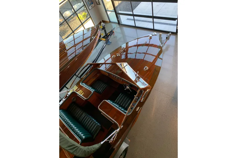 Slide: The Image of 2010 StanCraft 27 Lowboy boat with polished wood finish and green leather seats. - 5