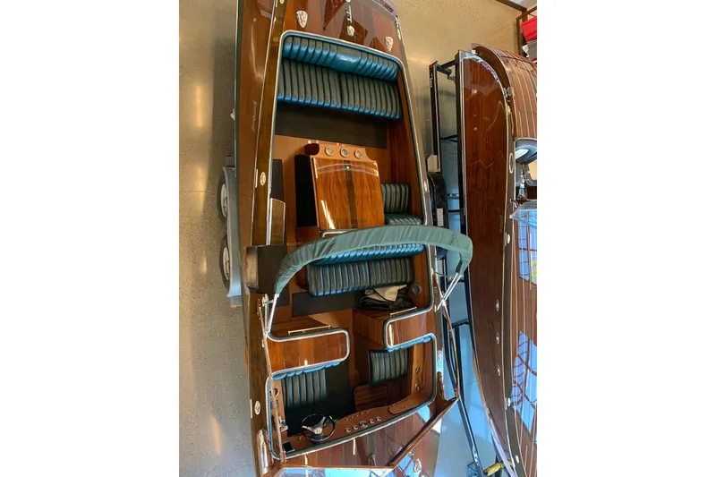 Slide: The Image of 2010 StanCraft 27 Lowboy boat with polished wood finish and green seating. - 6