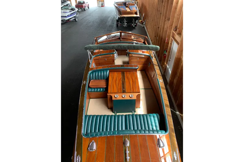Slide: The Image of 2010 StanCraft 27 Lowboy boat with polished wood finish and green leather seating. - 7