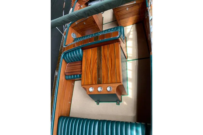 Slide: The Image of 2010 StanCraft 27 Lowboy boat interior with elegant wood and teal leather seating. - 9