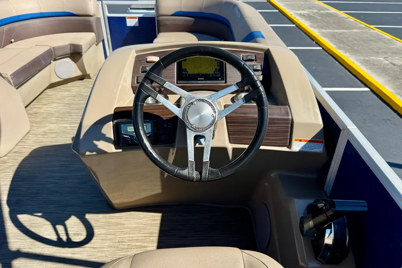 Slide: The Image of 2023 Bennington 23 SX boat interior with steering wheel and dashboard controls. - 14