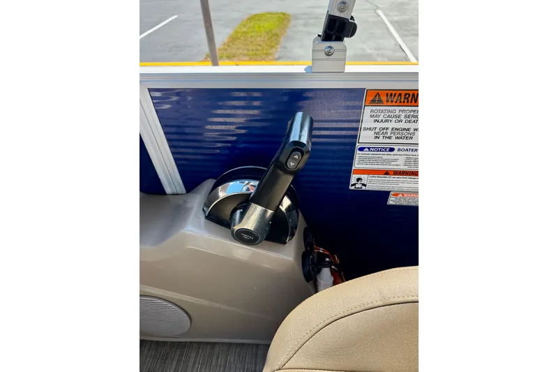 Slide: The Image of 2023 Bennington 23 SX boat throttle control with warning labels. - 18