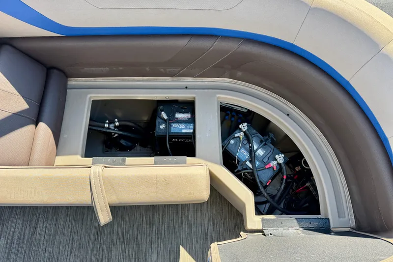 Slide: The Image of 2023 Bennington 23 SX boat interior showing battery compartment and seating area. - 26