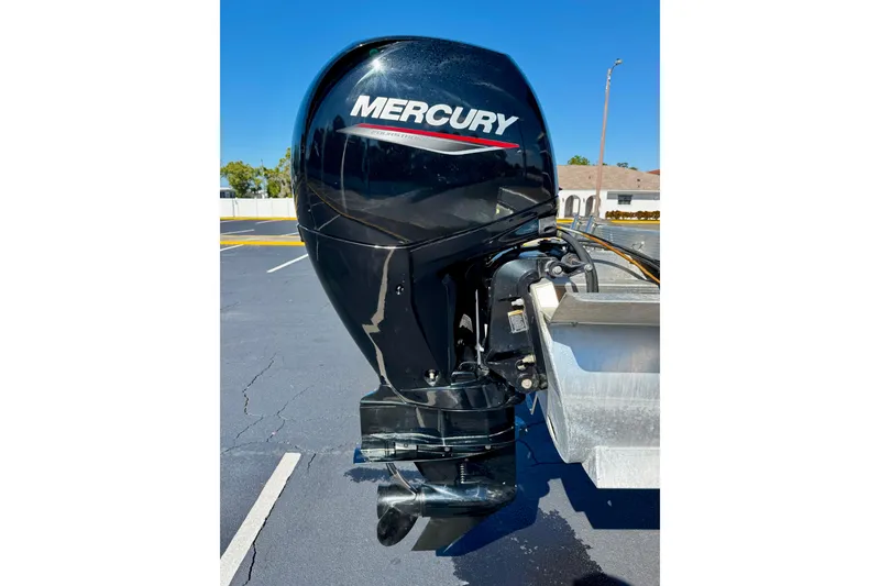 Slide: The Image of 2023 Bennington 23 SX with Mercury outboard motor in parking lot. - 32