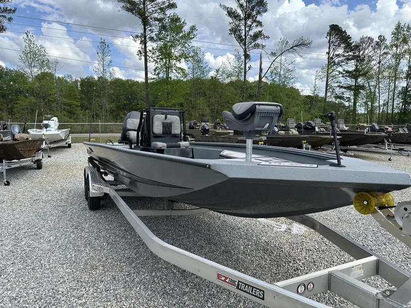 Slide: The Image of 2026 Excel 230 Bay Pro boat on trailer outdoors. - 2