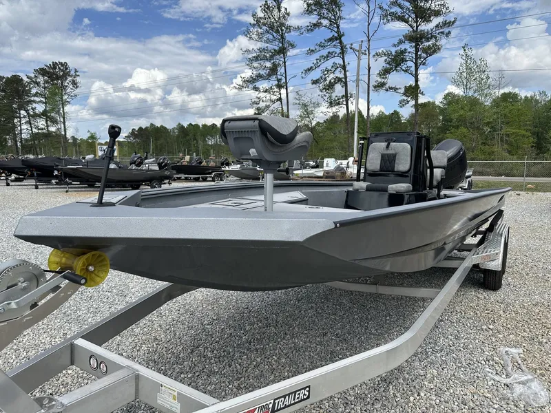 Slide: The Image of 2026 Excel 230 Bay Pro boat on trailer outdoors. - 3