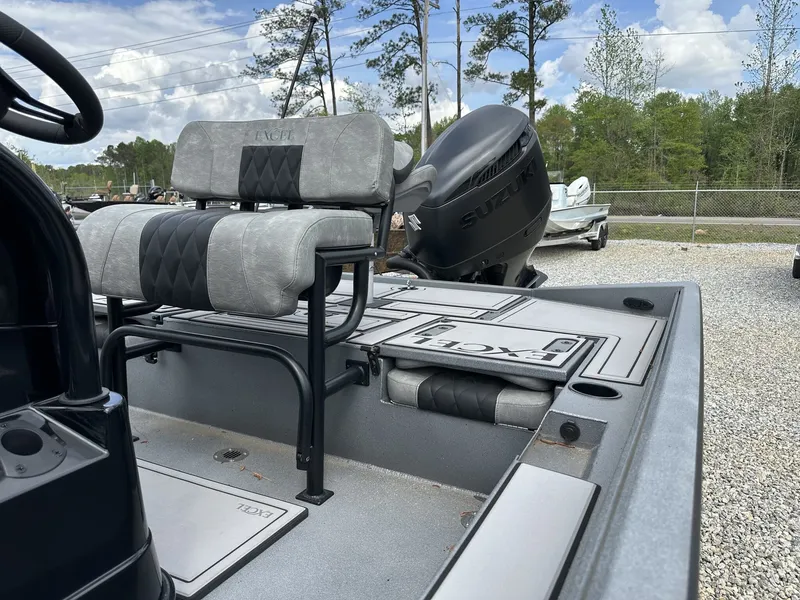 Slide: The Image of 2026 Excel 230 Bay Pro boat with Suzuki engine, gray upholstery. - 8