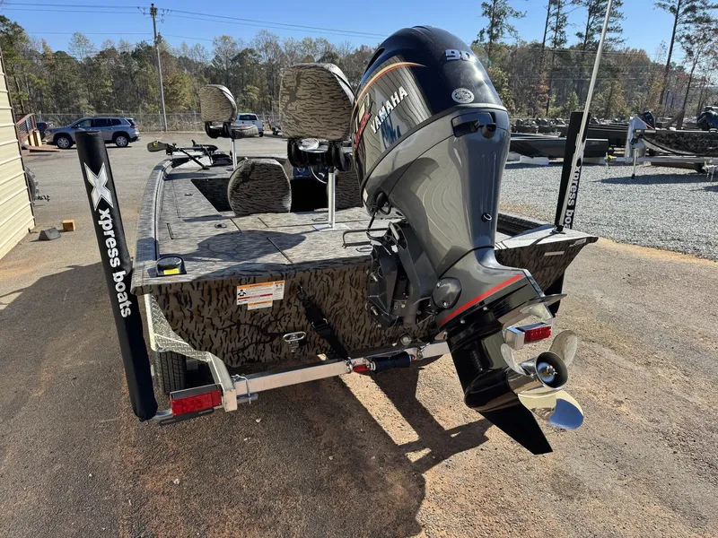 Slide: The Image of 2026 Xpress XP180 boat with Yamaha motor, parked outdoors on a sunny day. - 8