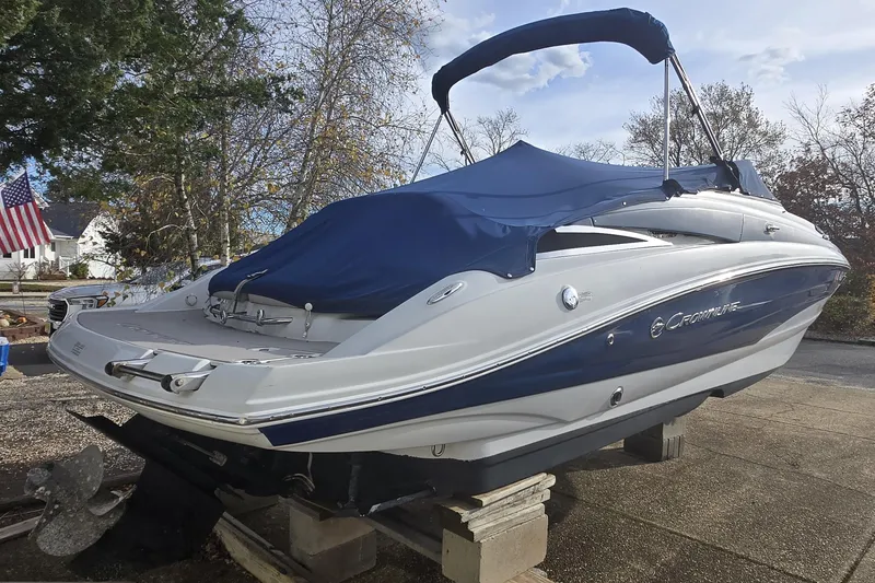 Slide: The Image of 2012 Crownline Eclipse E4 boat with blue cover on a driveway. - 10