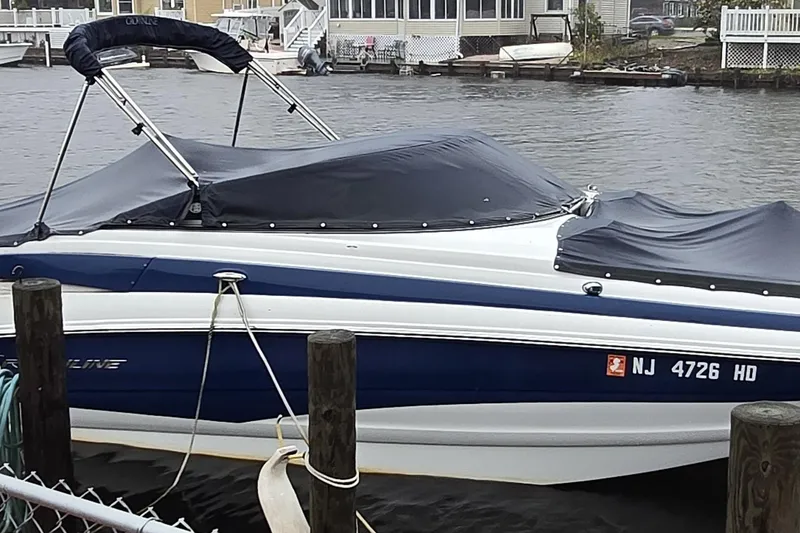 Slide: The Image of 2012 Crownline Eclipse E4 boat docked by waterfront homes. - 11