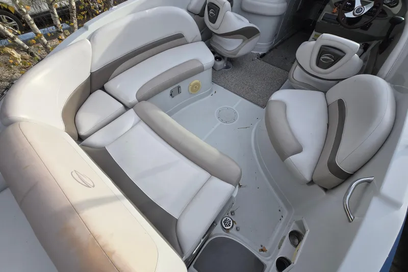 Slide: The Image of 2012 Crownline Eclipse E4 boat interior with beige and gray seating arrangement. - 16