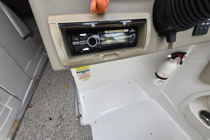 Slide: The Image of 2012 Crownline Eclipse E4 boat interior with stereo and fire extinguisher. - 18