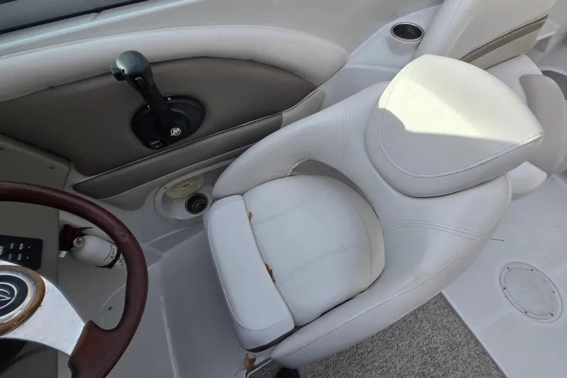 Slide: The Image of 2012 Crownline Eclipse E4 boat interior with white seating and control panel. - 24